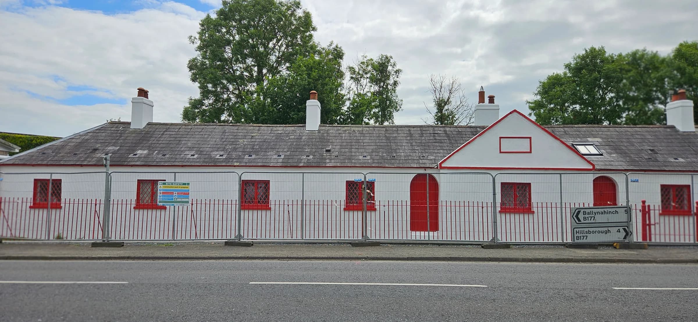 The terrace repainted crisp white with bright red windows, doors and gable trim, and red railings